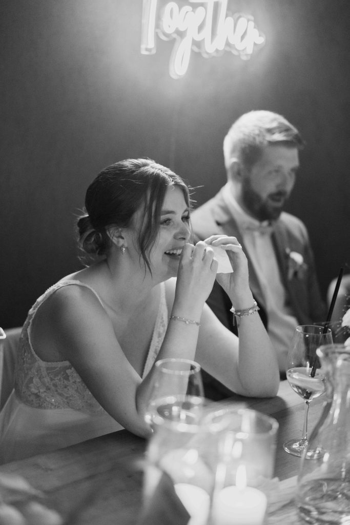 Glückliches Brautpaar beim Essen bei einer Hochzeit, romantische Atmosphäre.
